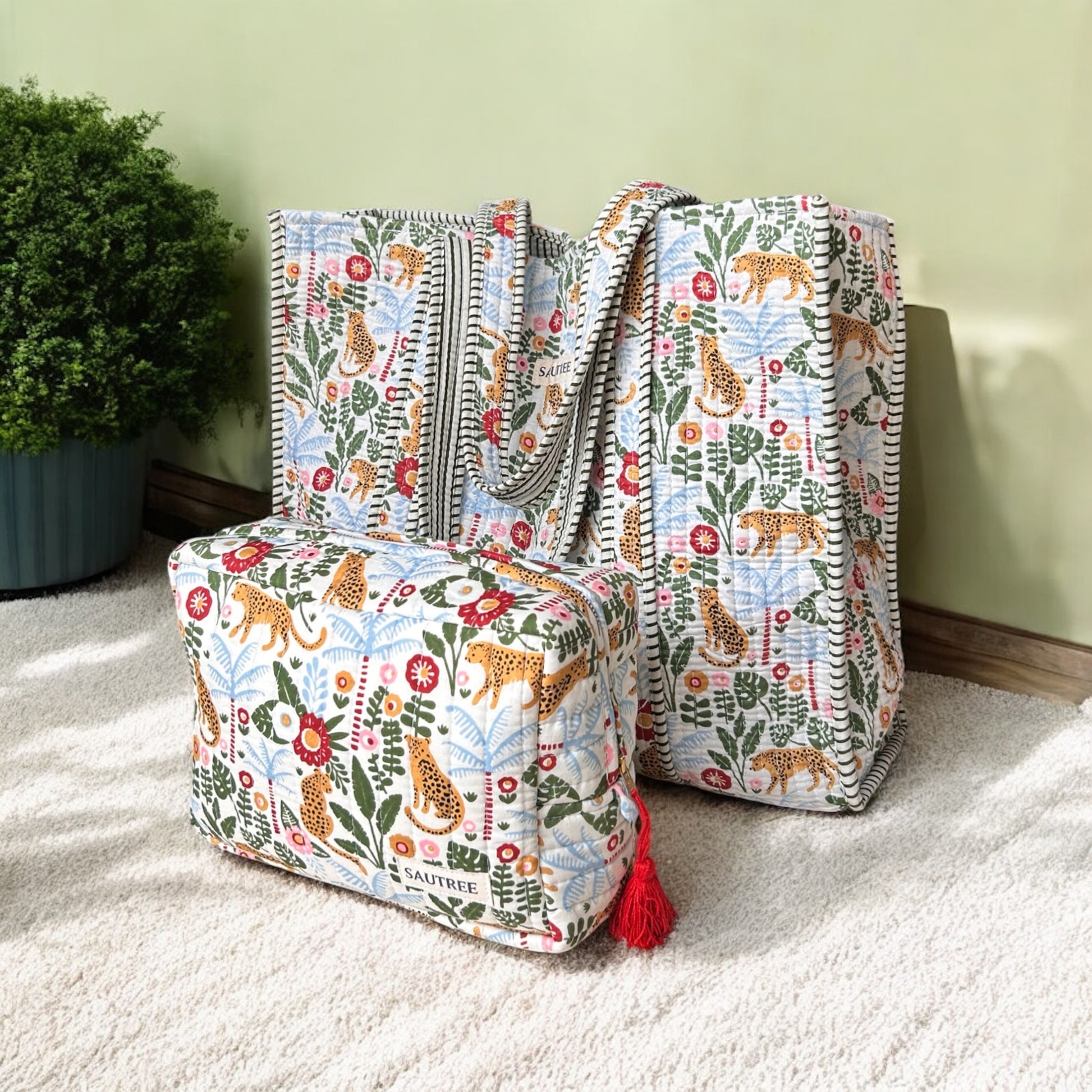 Two patterned bags with tassels on a carpeted floor.