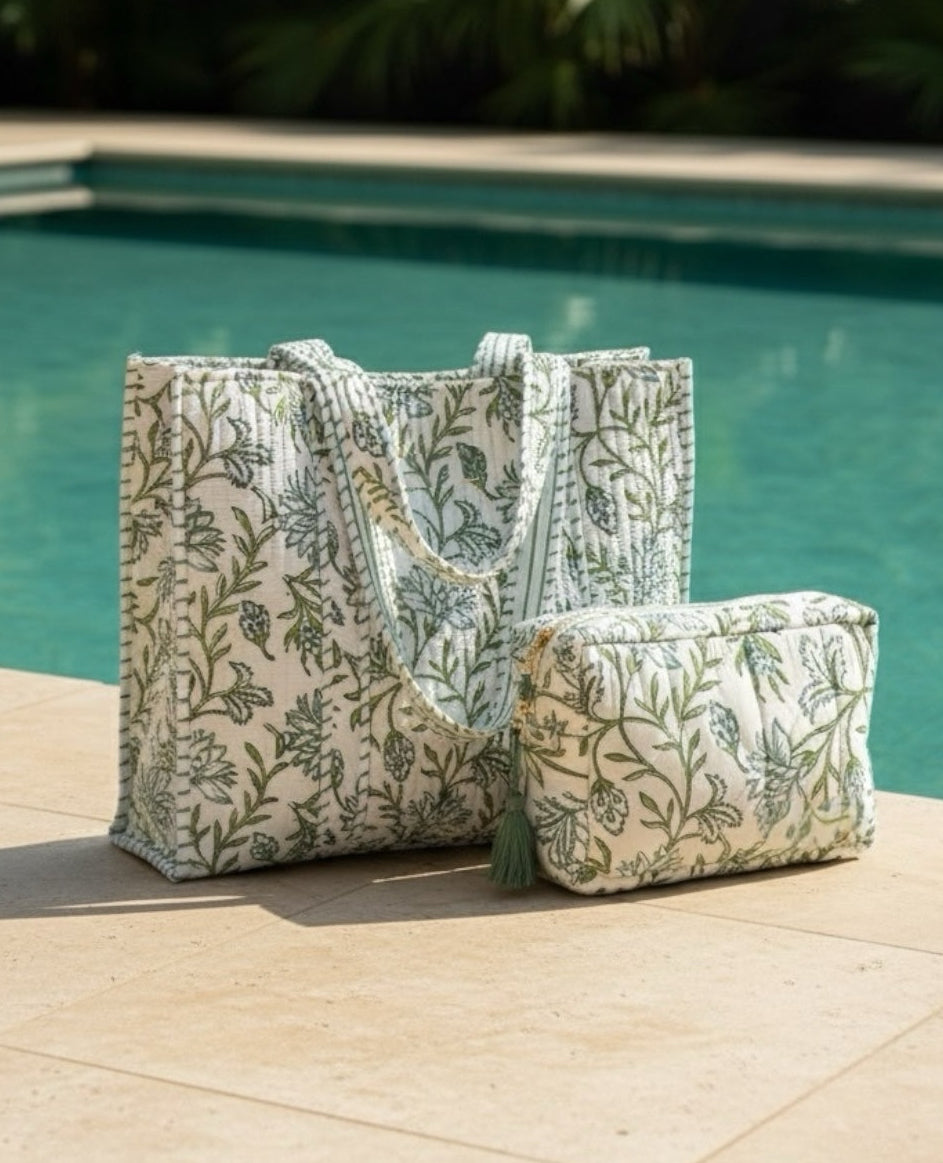 Floral-patterned tote bag and pouch by a poolside