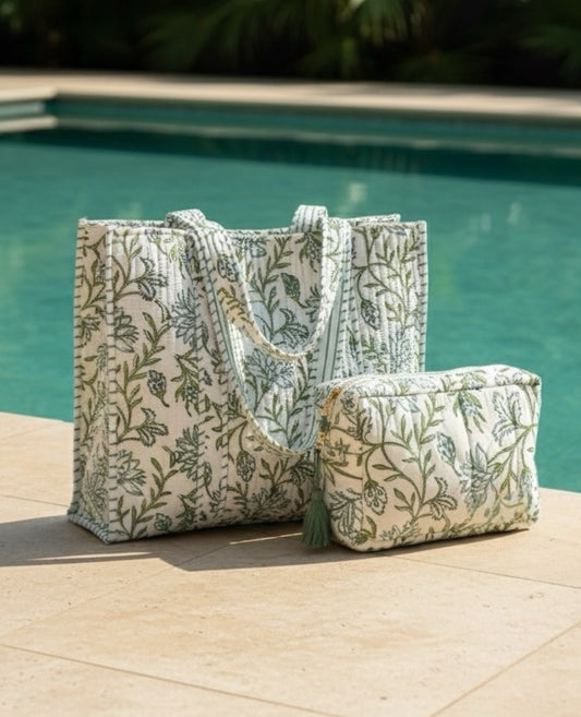 Floral-patterned tote bag and pouch by a poolside