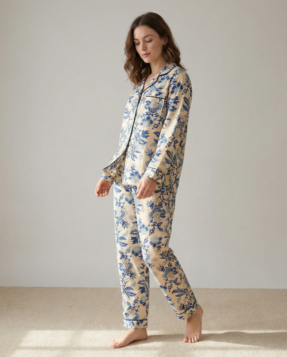 Woman wearing a floral pajama set against a plain background
